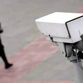 A police CCTV camera observes a woman walking. Picture: Leon Neal/AFP via Getty Images