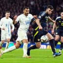 Greece's Vangelis Pavlidis (left) and Scotland's Grant Hanley. Cr: PA.