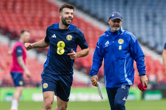 Scotland head coach Steve Clarke (R) and Grant Hanley.
