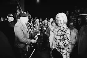 Winnie Ewing is welcomed by supporters, including two bagpipers, as she arrives in London to take her seat in the House of Commons in 1967