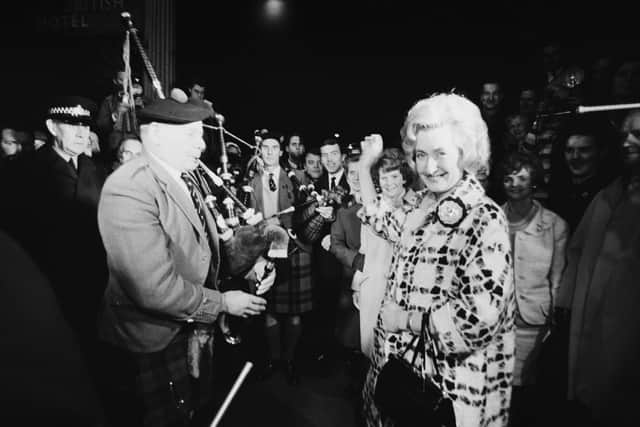 Winnie Ewing is welcomed by supporters, including two bagpipers, as she arrives in London to take her seat in the House of Commons in 1967