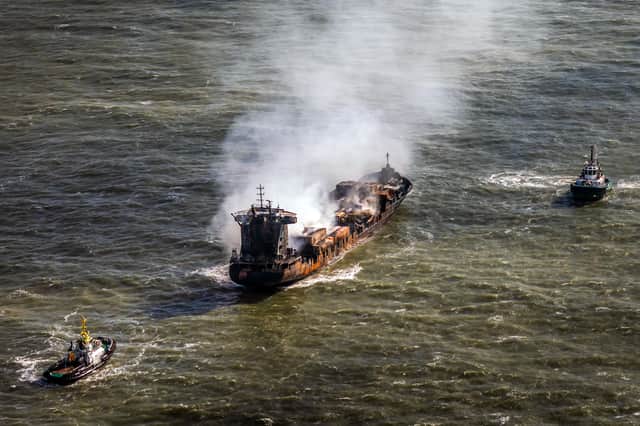 Tug boats shadow the Solong container ship as it drifts in the Humber Estuary, off the coast of East Yorkshire, following the collision with the MV Stena Immaculate oil tanker