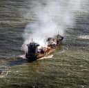 Tug boats shadow the Solong container ship as it drifts in the Humber Estuary, off the coast of East Yorkshire, following the collision with the MV Stena Immaculate oil tanker