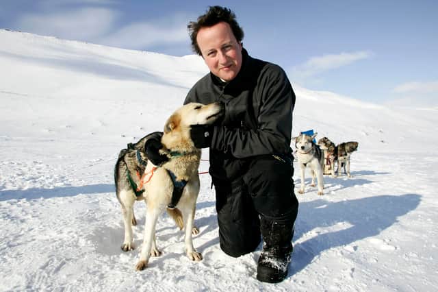 Former  Conservative Party leader David Cameron with husky dog Troika on the Scott-Turner glacier on the island of Svalbard, Norway