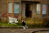 A young boy play football in the street in the Govan area of Glasgow