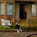 A young boy play football in the street in the Govan area of Glasgow