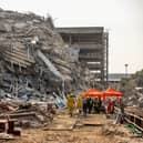 BANGKOK, THAILAND - MARCH 28: Thai rescue workers arrive on scene at a construction building collapse in the Chatuchak area following an earthquake on March 28, 2025 in Bangkok, Thailand. A powerful 7.7 magnitude earthquake struck Myanmar earlier today, causing strong tremors that were felt in Bangkok, where buildings swayed and hundreds of people evacuated onto the streets. (Photo by Lauren DeCicca/Getty Images)