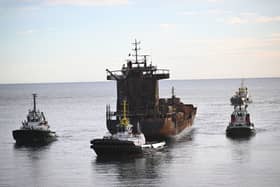 The stricken container ship, the Solong, which was involved in a collision with a tanker in the North Sea, is towed in to the port of Aberdeen