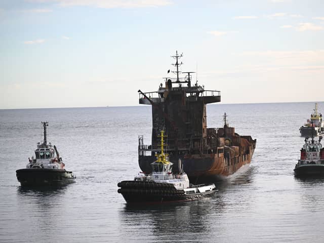 The stricken container ship, the Solong, which was involved in a collision with a tanker in the North Sea, is towed in to the port of Aberdeen