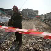 A rescuer at the site of a high-rise building under construction that collapsed after a 7.7 magnitude earthquake in Bangkok, Thailand
