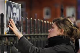 A woman touches a picture of Alexei Navalny at a protest opposite the Russian Embassy in London after the jailed Russian opposition leader died in prison. He was almost certainly murdered (Picture: Jonathan Brady)