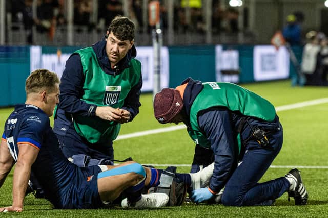 Duhan van der Merwe receives treatment for an ankle injury during Edinburgh's win over the Dragons.