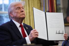 Donald Trump displays a signed, executive order to impose 25 per cent tariffs on all foreign-made cars. More tariffs are expected (Picture: Win McNamee)