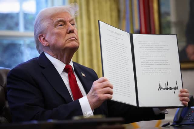 Donald Trump displays a signed, executive order to impose 25 per cent tariffs on all foreign-made cars. More tariffs are expected (Picture: Win McNamee)
