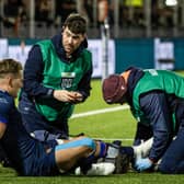 Edinburgh's Duhan van der Merwe receives medical attention after injuring his ankle against the Dragons.