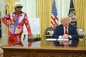 President Donald Trump speaks to reporters before signing an executive order in the Oval Office of the White House this week, as musician Kid Rock listens in