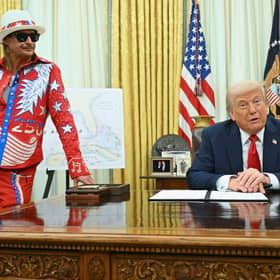 President Donald Trump speaks to reporters before signing an executive order in the Oval Office of the White House this week, as musician Kid Rock listens in