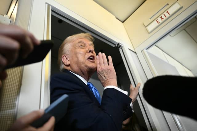 Donald Trump, seen talking to the media on Air Force One, is attempting a fundamental change in international relations that poses very real dangers for countries like the UK (Picture: Brendan Smialowski)