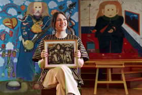 Charlotte Riordan, head of contemporary art at Lyon & Turnbull, holding a painting by the late John Byrne of The Beatles, which shows each Beatle seated beside a 'spirit animal'. Picture: Stewart Attwood/Lyon & Turnbull/PA Wire