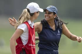 Megha Ganne of United States is congratulated by the her caddie Brooke Riley after scoring a record 63 in the first round of the Augusta National Women's Amateur at Champions Retreat Golf Club