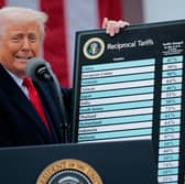 President Donald Trump holds up a chart of "reciprocal tariffs" while speaking during a trade announcement event in the Rose Garden at the White House