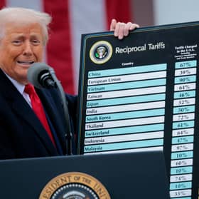 President Donald Trump holds up a chart of "reciprocal tariffs" while speaking during a trade announcement event in the Rose Garden at the White House