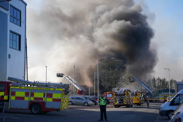 Fire fighters at the scene of a fire at an industrial unit in Broomlee Road, Cumbernauld, North Lanarkshire. Picture: Andrew Milligan/PA Wire