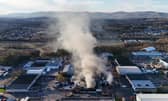Fire fighters at the scene of a fire at an industrial unit in Broomlee Road, Cumbernauld, North Lanarkshire. Picture: Andrew Milligan/PA Wire