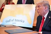 Donald Trump with a map showing the northern part of the Gulf of Mexico (Picture: Roberto Schmidt)