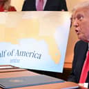 Donald Trump with a map showing the northern part of the Gulf of Mexico (Picture: Roberto Schmidt)