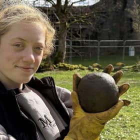 Magnet Fishing Edinburgh's Eryn and the 350-year-old cannonball found in the River Lochy in the Scottish Highlands. 