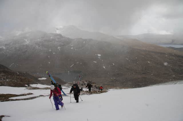 As a blizzard begins, competitors make their way to the contest face on Meall nan Tarmachan for the inaugural Lawers of Gravity freeride ski and snowboard event in 2015. 