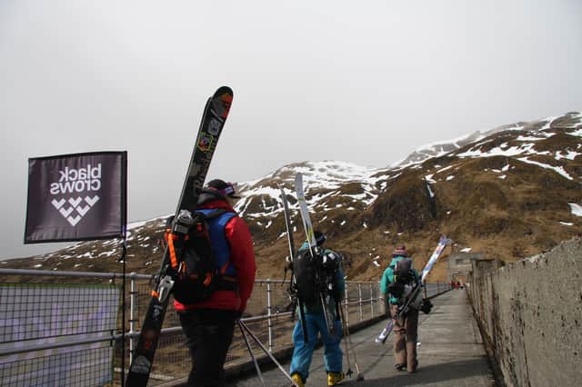 Competitors cross the Lawers Dam on their wat to the first Lawers of Gravity freeride event in 2015