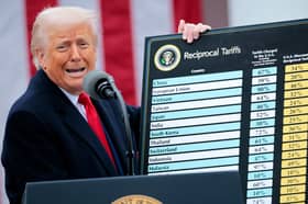 Donald Trump holds up a chart showing what tariff will be charged on imports from different countries around the world (Picture: Chip Somodevilla)