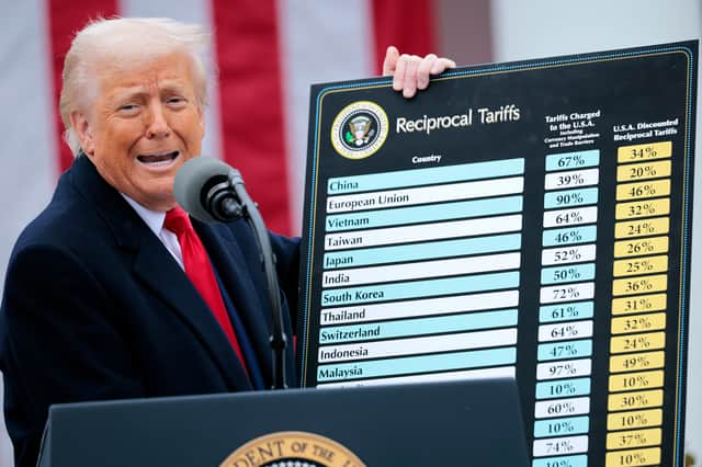 Donald Trump holds up a chart showing what tariff will be charged on imports from different countries around the world (Picture: Chip Somodevilla)