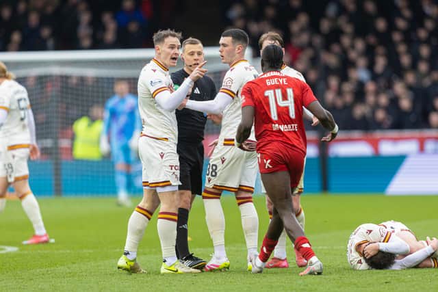 Motherwell players protest for Aberdeen's Pape Habib Gueye to be sent off for his foul on Andy Halliday. (Photo by Mark Scates / SNS Group)