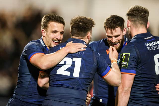 Edinburgh's Ali Price celebrates with Ross McCann as he scores the fourth try against Lions.