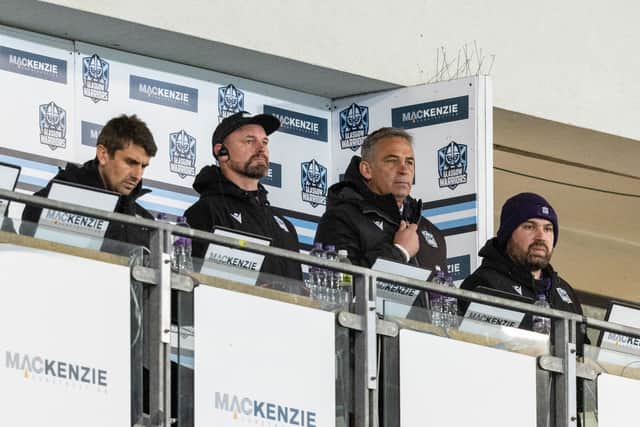 Franco Smith and his fellow Glasgow Warriors coaches watch on.