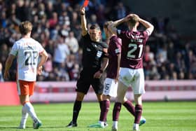 Referee Nick Walsh shows a red card to Hearts' James Wilson during the match against Dundee United at Tynecastle. (Photo by Ross Parker / SNS Group)