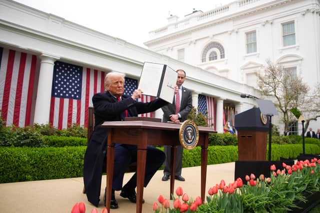 Donald Trump displays an executive order imposing tariffs on imported goods during his 'Make America Wealthy Again' trade announcement at the White House (Picture:  Andrew Harnik)