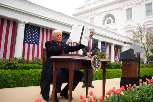 Donald Trump displays an executive order imposing tariffs on imported goods during his 'Make America Wealthy Again' trade announcement at the White House (Picture:  Andrew Harnik)