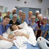 Grace and Angus Davidson (front) with the hospital team following the birth of baby Amy Isabel Davidson (Picture: Womb Transplant UK)