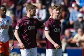Hearts forward James Wilson (right) is consoled by team-mate Blair Spittal following his red card against Dundee United. (Photo by Mark Scates / SNS Group)