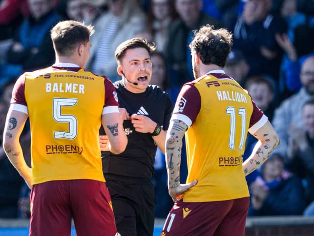 Referee Matthew MacDermaid checks the VAR monitor before sending off Motherwell's Kofi Balmer during the match against Kilmarnock at Rugby Park. (Photo by Craig Foy / SNS Group)