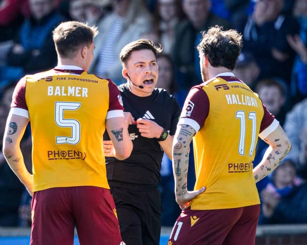 Referee Matthew MacDermaid checks the VAR monitor before sending off Motherwell's Kofi Balmer during the match against Kilmarnock at Rugby Park. (Photo by Craig Foy / SNS Group)