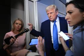 White House Press Secretary Karoline Leavitt, left, seen with Donald Trump on Air Force One, says everyone should 'trust in President Trump' (Picture: Mandel Ngan)