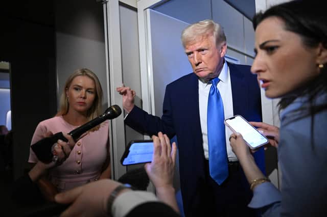 White House Press Secretary Karoline Leavitt, left, seen with Donald Trump on Air Force One, says everyone should 'trust in President Trump' (Picture: Mandel Ngan)