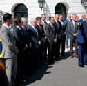 President Donald Trump gestures as he speaks to the media during a photo opportunity at the White House on Wednesday, as he hosts racing car drivers and team owners for a visit