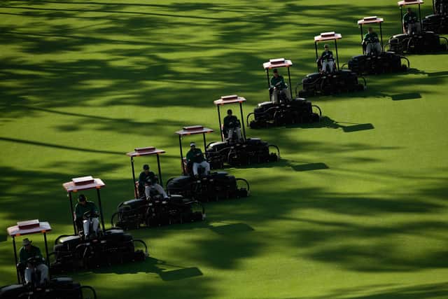 Mowers cut the fairway prior to the start of the Masters Tournament at Augusta National Golf Club