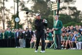 Honorary Starter Gary Player of South Africa plays his shot from the first tee at Augusta National Golf Club watched by Masters chairman Fred Ridley 